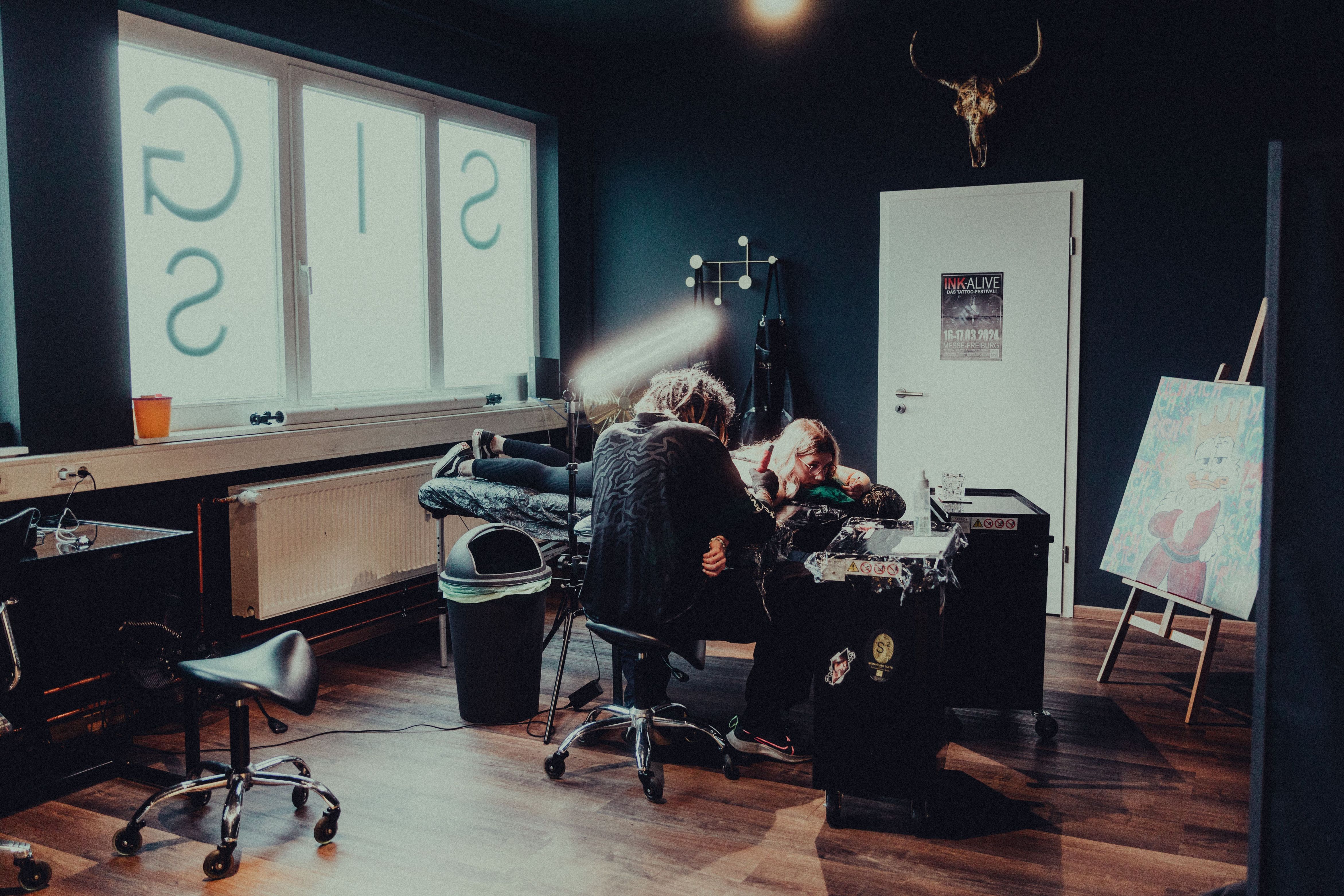 The Wame Ink studio floor at night, one station lit and in session.